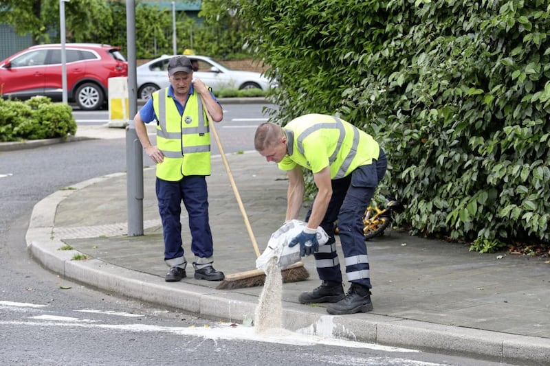 Council workers clear up after paint bomb attacks on the Mountpottinger Road in the Short Strand area. Picture by Mal McCann 
