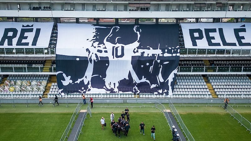 Pele’s coffin is carried onto the pitch at the Vila Belmiro Stadium in Santos on Monday (Matias Delacroix/AP)
