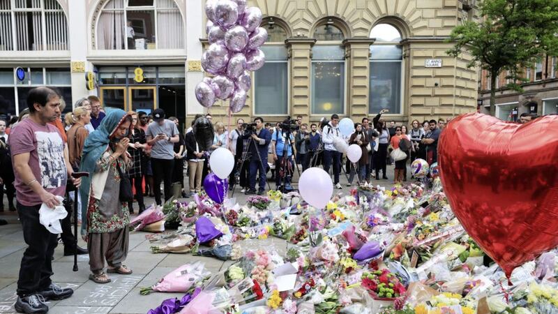 People look at flowers in St Ann&#39;s Square, close to the Manchester Arena where a suicide bomber killed 22 people leaving a pop concert at the venue on Monday. Valuing our freedoms means not allowing terrorists to remove them. 