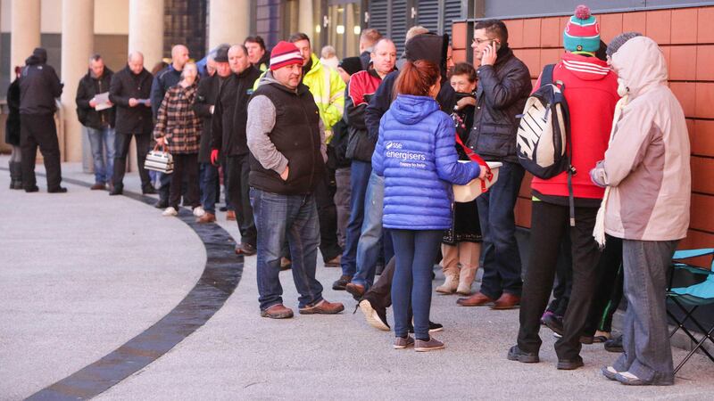 Adele fans queuing outside the SSE Arena this morning are given hot drinks by staff. Picture by Brian Thompson