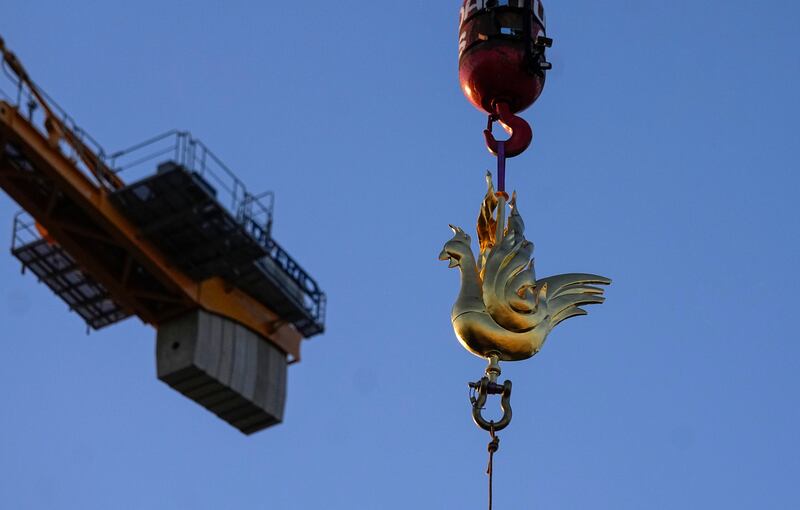 The replica of the golden rooster is craned up to the top of the Notre Dame cathedral spire as part of restoration works (AP Photo/Michel Euler)