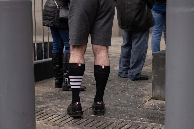 Fashion designer Thom Browne is seen wearing socks with four stripes outside Manhattan federal court in New York