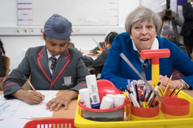 Theresa May with school children (Stefan Rousseau/PA)