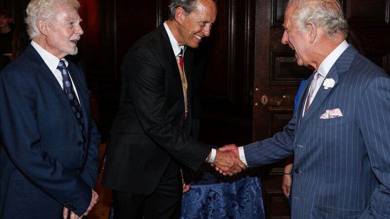 Charles greets Derek Jacobi and Richard E Grant during a reception (Adrian Dennis/PA)