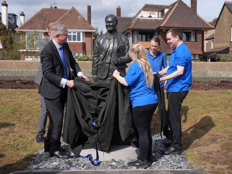 Andrew Rosindell, left, and members of the Music Man Project unveil the statue of Sir David Amess