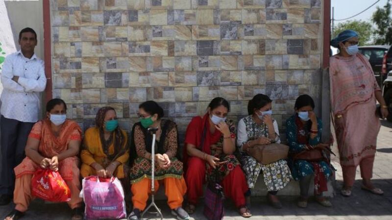 &nbsp;Indian health workers wait for transport outside a hospital in Jammu, India, on May 26, 2020.&nbsp;Picture by&nbsp;Channi Anand, AP&nbsp;