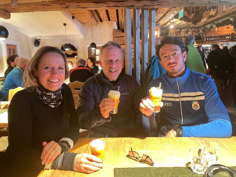 Chris enjoys a potent Bombardino at Jimmi’s Hut with pal Susie and skiing instructor Marco