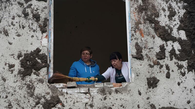 Staff sweep away debris after a Russian attack on a mental health facility in Kharkiv, Ukraine (Andrii Marienko/AP)