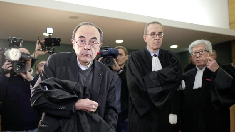 Cardinal Philippe Barbarin, centre, takes his seat as he arrives at the Lyon courthouse with his lawyers. Picture by Laurent Cipriani, Associated Press 