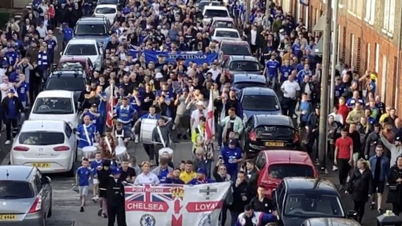 Footage shared online shows Chelsea fans marching towards Windsor Park with a loyalist flute band. 