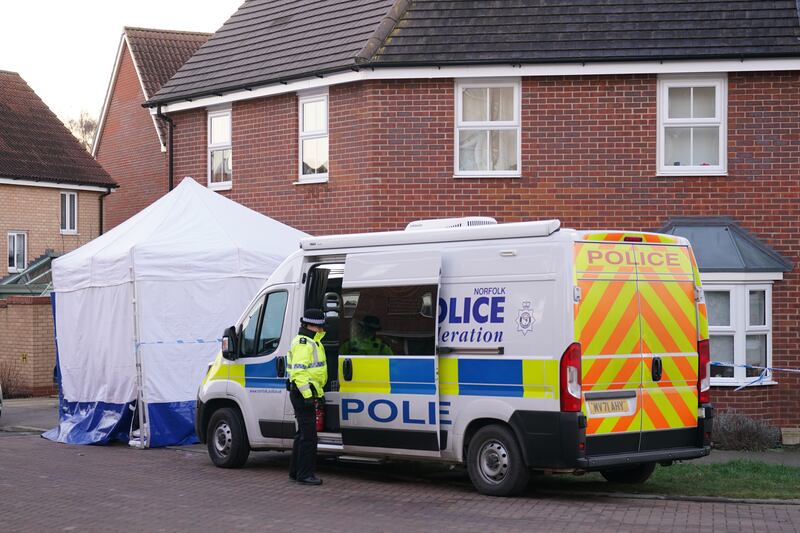 Police outside a house in Costessey near Norwich after four people were found dead inside the property