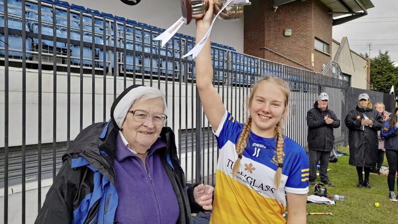 St Louis captain Sarah Fyfe accepts the All-Ireland senior Cup from Sr M&Atilde;&iexcl;ir&Atilde;&uml;ad N&Atilde;&shy; Fhear&Atilde;&iexcl;in, All-Ireland Schools&acirc;�� Camogie President 