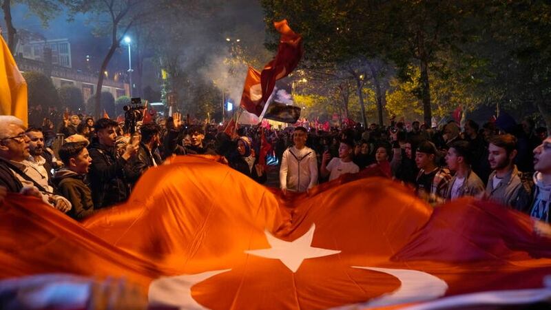 Supporters of President Recep Tayyip Erdogan celebrate outside AKP (Justice and Development Party) headquarters in Istanbul (Khalil Hamra/AP)