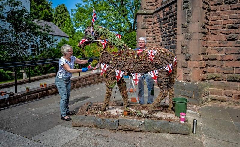 Wendy Doig and Roy Barker from St James Church in Woolton Village dress Jimmy the War Horse ahead of VE Day celebrations