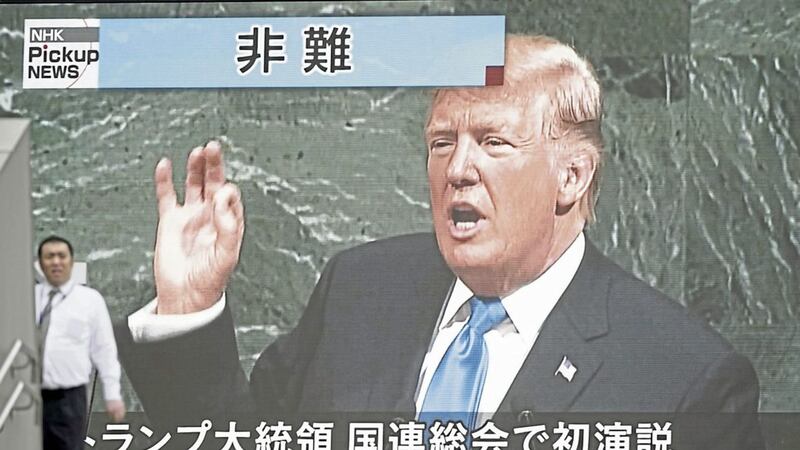 A man walks past a TV screen showing President Trump speaks at the UN general assembly in Tokyo, Wednesday PICTURE: Eugene Hoshiko/AP 
