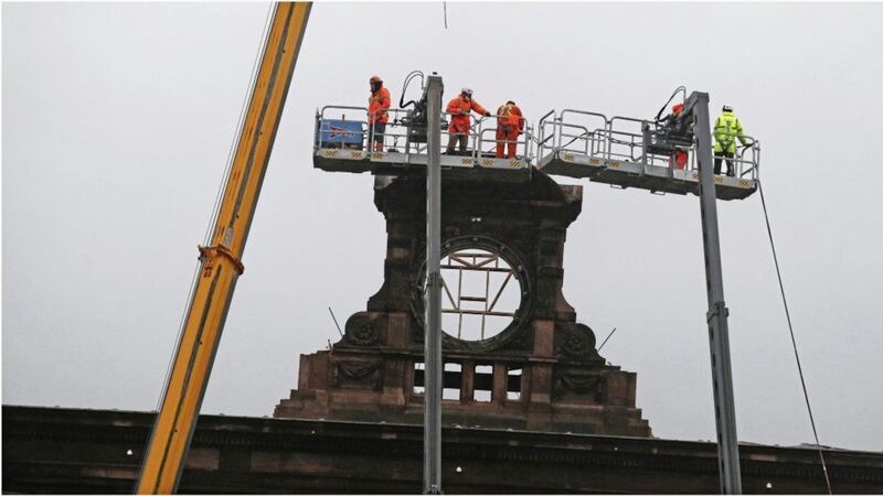 Engineers and workers dismantle the iconic Bank Buildings clock in Belfast. Picture by Hugh Russell.