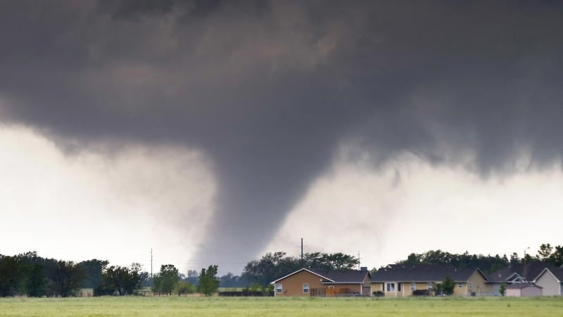 A tornado passes near Halstead, Kan., Wednesday, May 6, 2015. A swath of the Great Plains is under a tornado watch Wednesday, including parts of North Texas, Oklahoma, Kansas and Nebraska. (Travis Heying/The Wichita Eagle via AP) 