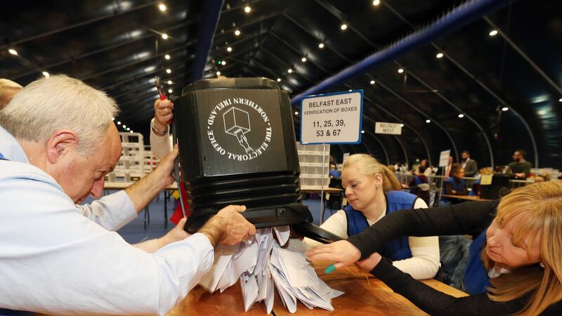 Volunteers empty a ballot box in the counting centre at the Titanic Exhibition Centre, Belfast, after elections to decide the make-up of the next Stormont Assembly. Picture by Liam McBurney, Press Association&nbsp;