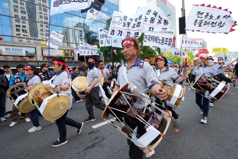Members of the Korean Confederation of Trade Unions beat their drums during a May Day rally in Seoul (Ahn Young-joon/AP)