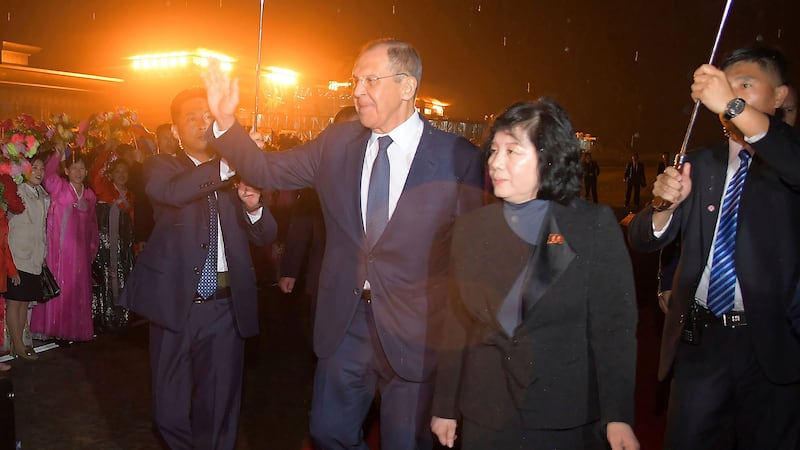 Russian foreign minister Sergey Lavrov, centre left, escorted by North Korean foreign minister Choe Son Hui, centre right, is welcomed on his arrival at Pyongyang international airport (Korean Central News Agency/Korea News Service via AP)