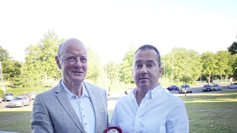 Queen's handball official Richard Murphy (left) presents Pearse McCormick with his achievement award