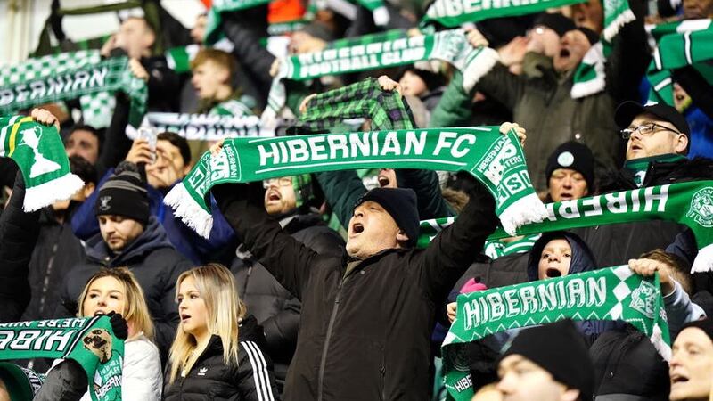 Hibernian fans hold up scarves in memory of chairman Ron Gordon who died on 21st February prior to kick-off in the cinch Premiership match at Easter Road, Edinburgh. Picture date: Wednesday March 8, 2023.