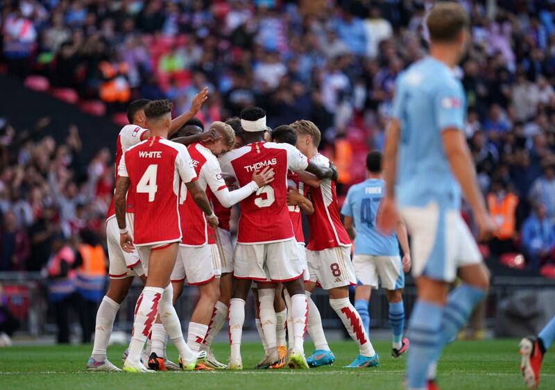 Arsenal players celebrate after Leandro Trossard (hidden) equalises