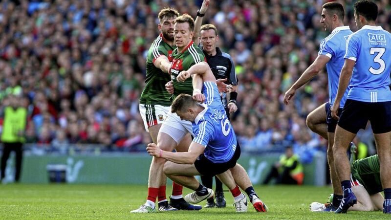 Mayo&#39;s Donal Vaughan follows through on Dublin&#39;s John Small in the 2017 All-Ireland SFC final. Picture by Seamus Loughran. 