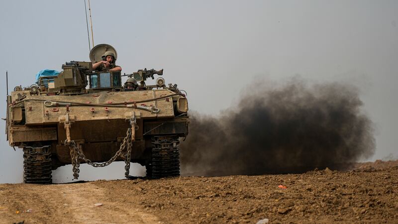 An Israeli armoured personnel carrier moves near the Gaza Strip border, in southern Israel (Ohad Zwigenberg/AP)