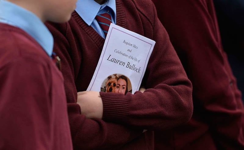 &nbsp;A student holds a funeral missalette with a picture of Lauren Bullock and her dog, Benji. Picture by Mark Marlow&nbsp;