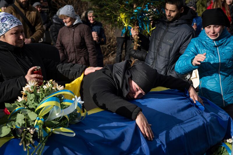 Hanna Boichuk cries during the funeral of her son Vasyl Boichuk, a Ukrainian serviceman killed in Mykolayiv in March 2022, in Verkhovyna, Ukraine, on Tuesday December 26 2023 (Evgeniy Maloletka/AP)