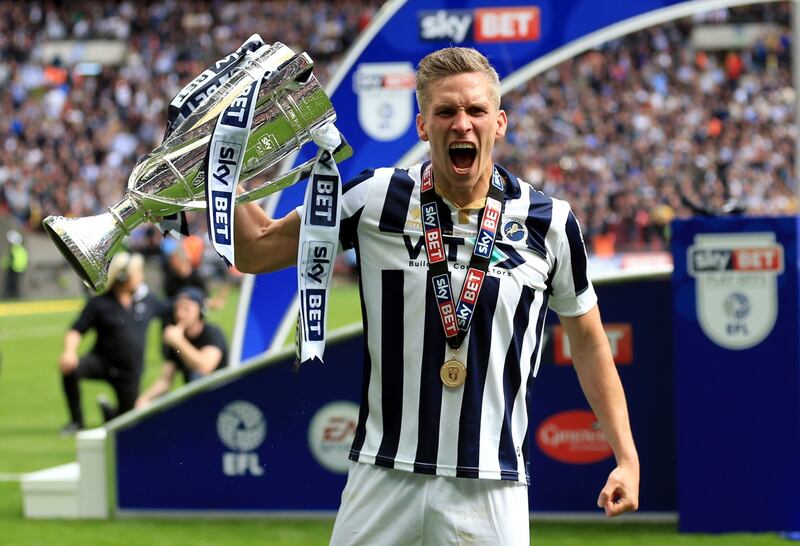 Morison later celebrated with the trophy (Nigel French/PA)