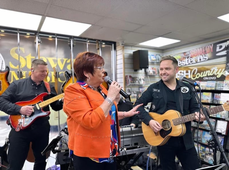 Susan McCann performing with Derek Ryan during the launch of her album at Stewart's Music Shop in Dungannon