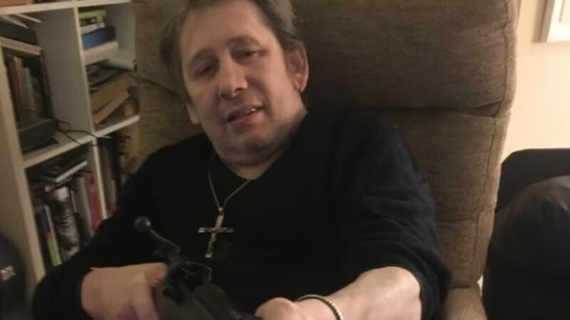 Pogues' singer Shnane Magowan pictured with the missing rifle