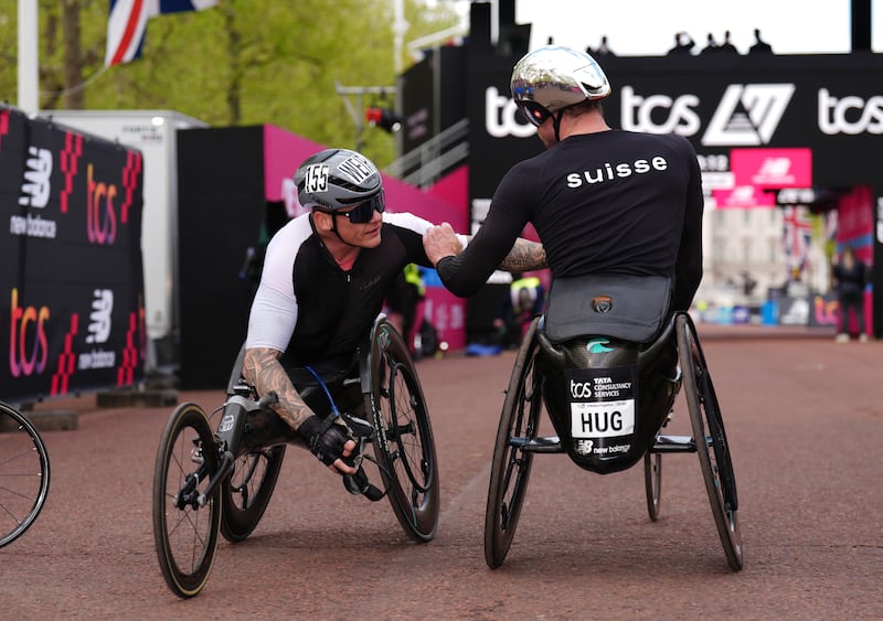 Third place David Weir congratulates Marcel Hug on winning the men’s wheelchair race during the TCS London Marathon