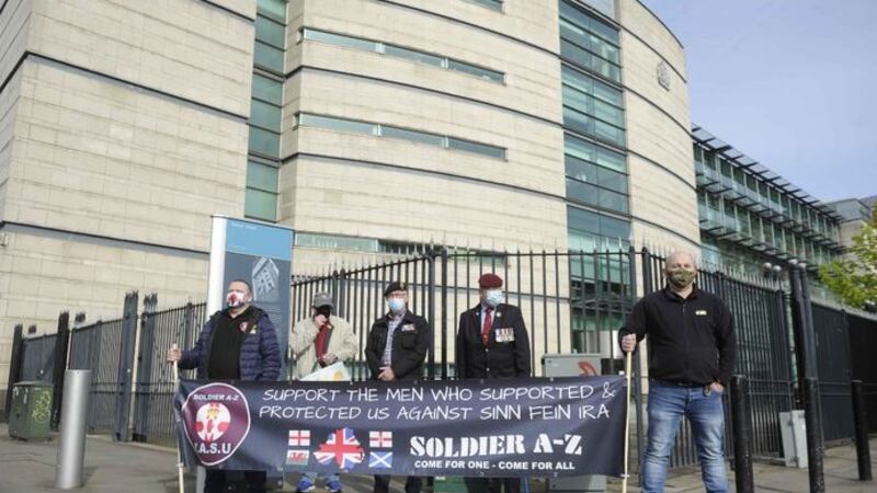 Supporters of two former paratroopers accused of the murder of an Official IRA leader before the men were formally acquitted after prosecutors offered no further evidence at their trial