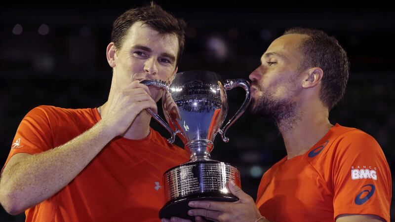 Jamie&nbsp;Murray, left, and Bruno Soares hold their trophy after defeating Daniel Nestor and Radek Stepanek in the men's doubles final at the Australian Open&nbsp;