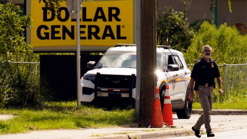 Law enforcement officials continue their investigation at a Dollar General store that was the scene of a mass shooting in Jacksonville, Florida (John Raoux/AP)