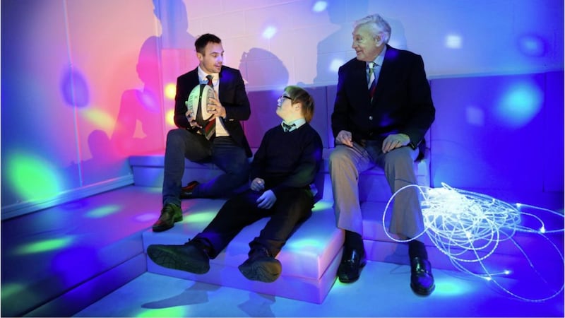Ireland Ulster Rugby legends Tommy Bowe and Willie John McBride officially open a new sensory classroom at St Gerard's School and Support Services in west Belfast yesterday with the help of pupil Ryan Guest. Pictures by Hugh Russell
