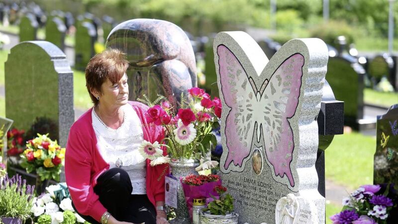 Loretta Nolan beside her daughter Emma&#39;s grave in Hannahstown Cemetery. Picture by Mal McCann 