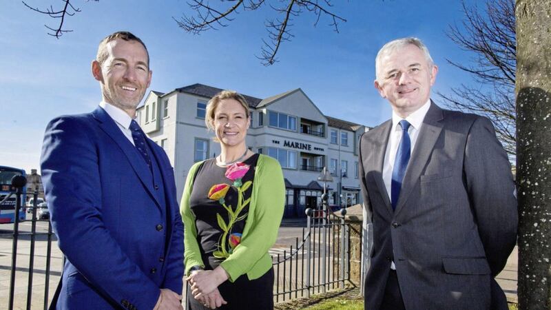 Marine Hotel owners Colum McLornan and Claire Hunter pictured with Stephen Comer from First Trust Bank outside its newly refurbished premises. 