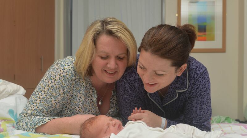 Proud new mum Emma McErlane (right) with her partner Michelle Devlin and their daughter who was born at 3.50am