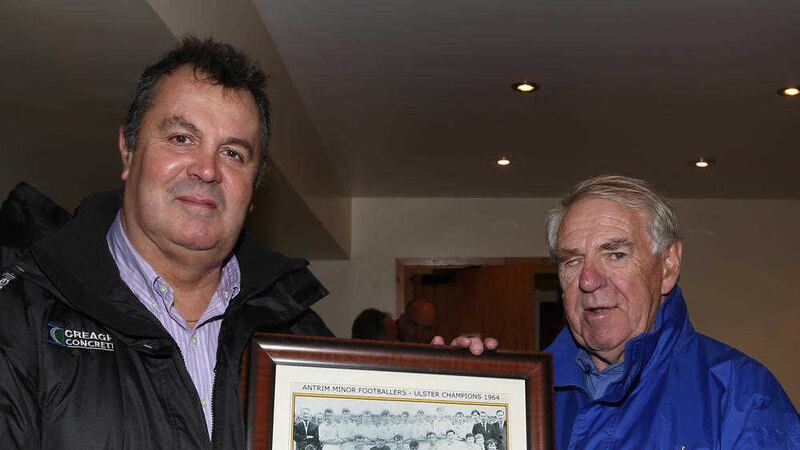 County chairman Jim Murray (left) presents a framed picture of Antrim's Ulster Minor Football Championship-winning team of 1964 to Gerry Barry in 2014&nbsp;Picture by John McIlwaine