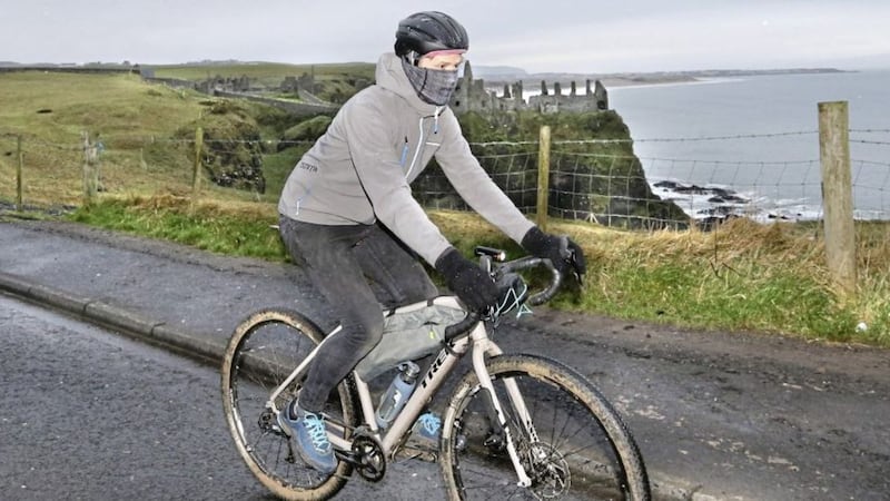 A cyclist passes Dunluce Castle on the Antrim coast yesterday. Picture by Margaret McLaughlin 