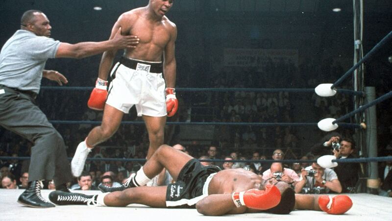 Muhammad Ali, aged 22, stands over a prone Liston, as he becomes heavyweight champion. He retired on this day, but came back to the ring a year later, when he was beaten by Larry Holmes.&nbsp;