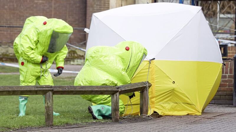Personnel in hazmat suits securing a tent covering a bench in the Maltings shopping centre in Salisbury as they investigate the poisoning of Russian spy Sergei Skripal and his daughter Yulia. Picture by Andrew Matthews/PA. 