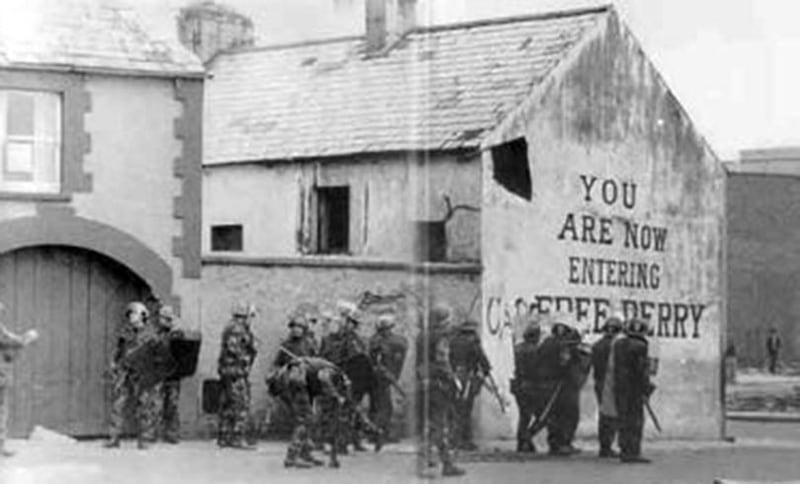British army soldiers line up at the gable wall of 33 Lecky Road&nbsp;