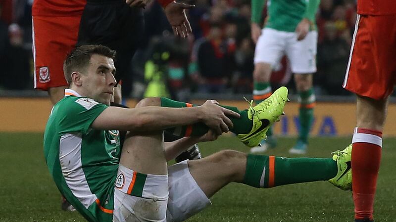 Republic of Ireland captain Seamus Coleman holding his broken leg following the challenge by Wales' Neil Taylor in March.