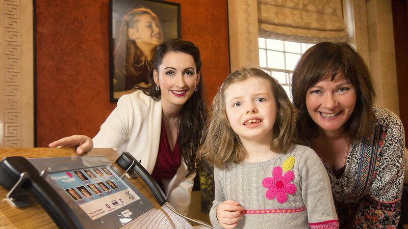 Junior ministers Emma Pengelly and Jennifer McCann pictured with Olivia Curran 