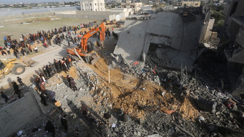 Palestinians look at the destruction after an Israeli strike on a residential building in Rafah, Gaza Strip (Hatem Ali/AP)